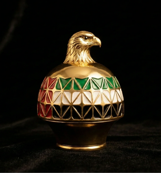 Gold UAE perfume cap with falcon head and UAE flag colors on black background